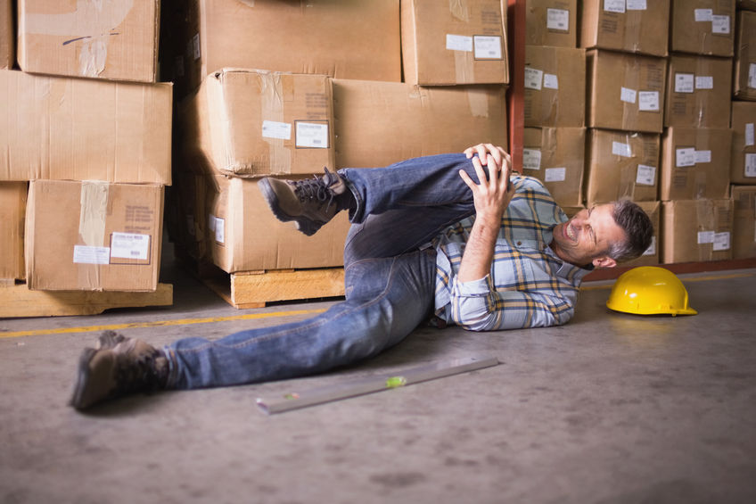 31910011 - side view of male worker lying on the floor in warehouse